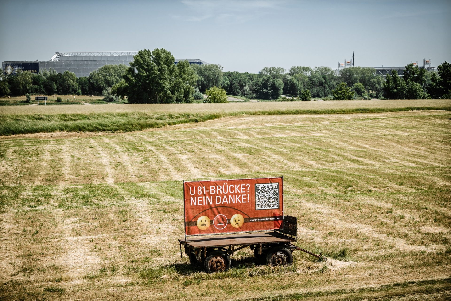 Etwa an der Stelle, auf dem Bürger*innen gegen eine U81-Brücke protestieren, würde das Bauwerk über den Rhein kommen. Im Hintergrund: Arena und Messe. Foto: Andreas Endermann